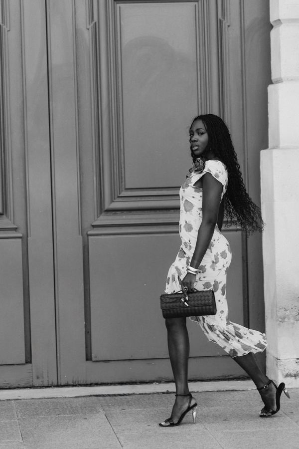Portrait of a woman in floral off-shoulder dress, dark clutch, Place Vendôme, Paris