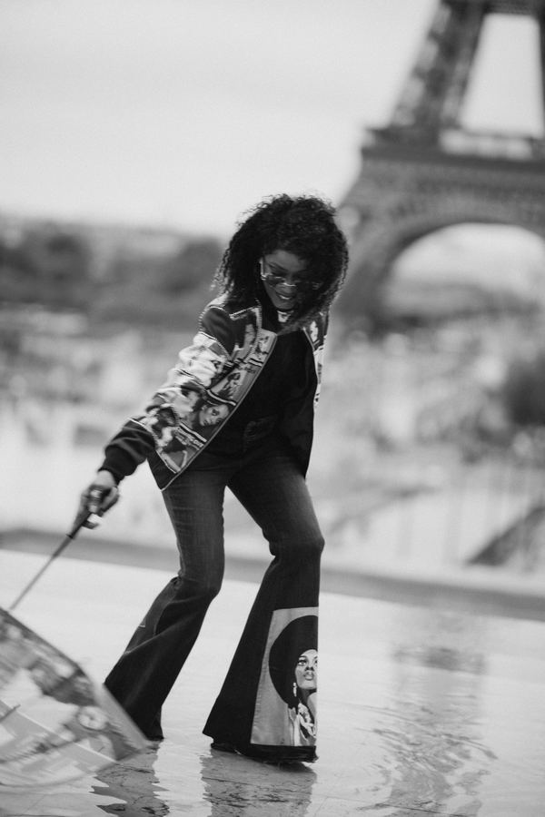 Portrait of a woman in printed bomber jacket, black flared trousers, transparent umbrella, Trocadéro, Paris