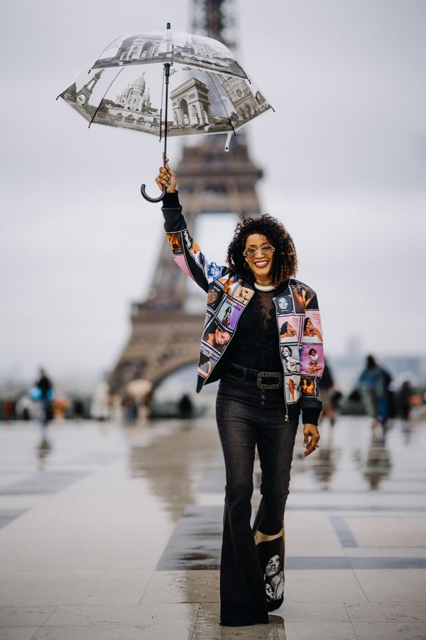 Portrait of a woman in printed bomber jacket, black flared trousers, transparent umbrella, Trocadéro, Paris