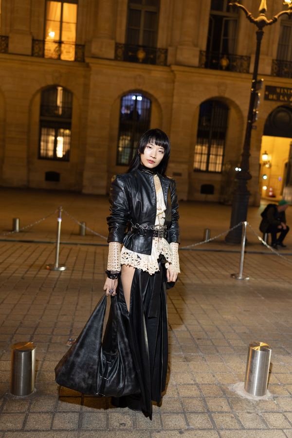 Street style: black leather jacket, cream lace blouse, long black skirt, Place Vendôme, Paris at night