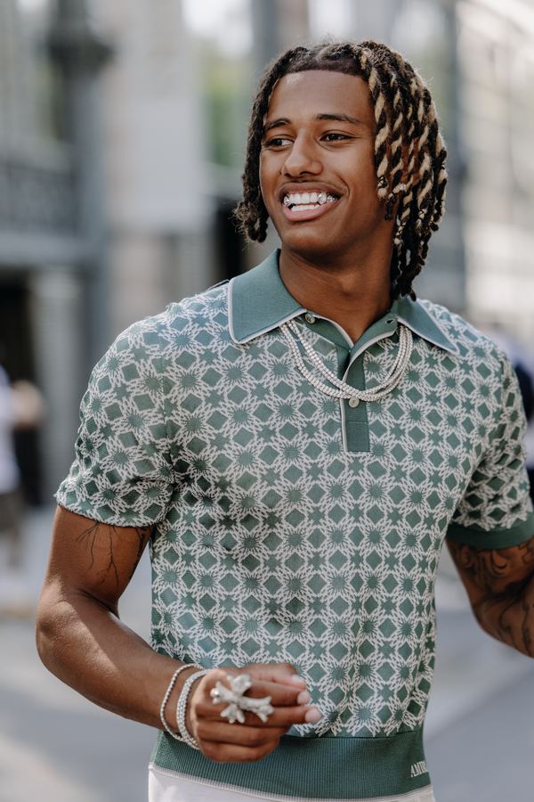 Street style at Paris Fashion Week: green patterned knit polo, white trousers, Paris