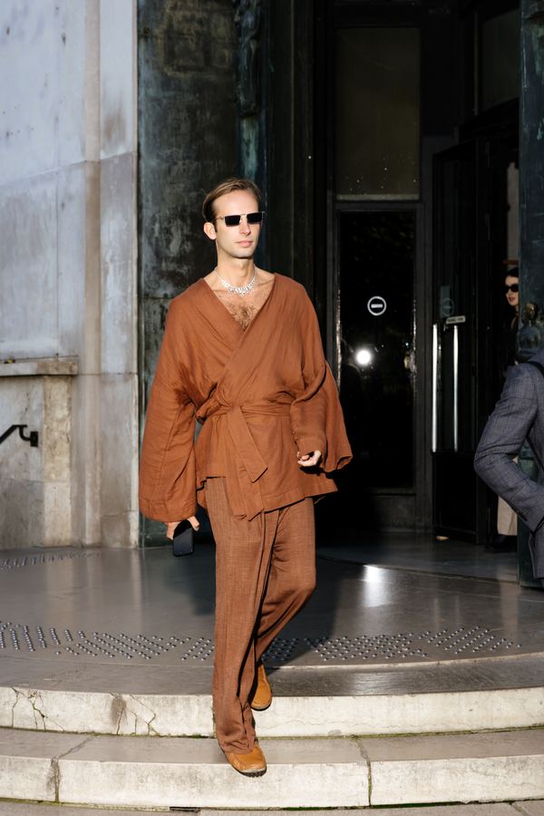 Street style at Paris Fashion Week: rust wrap shirt, rust wide trousers, brown shoes, show venue entrance, Paris