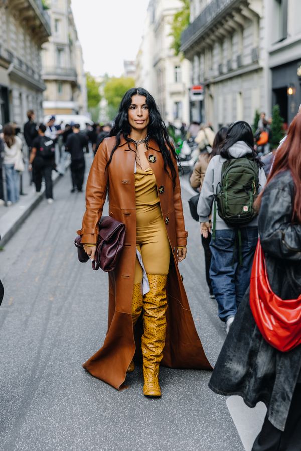 Street style at Paris Fashion Week: rust leather long coat, mustard over-the-knee boots, mustard bodysuit, Paris