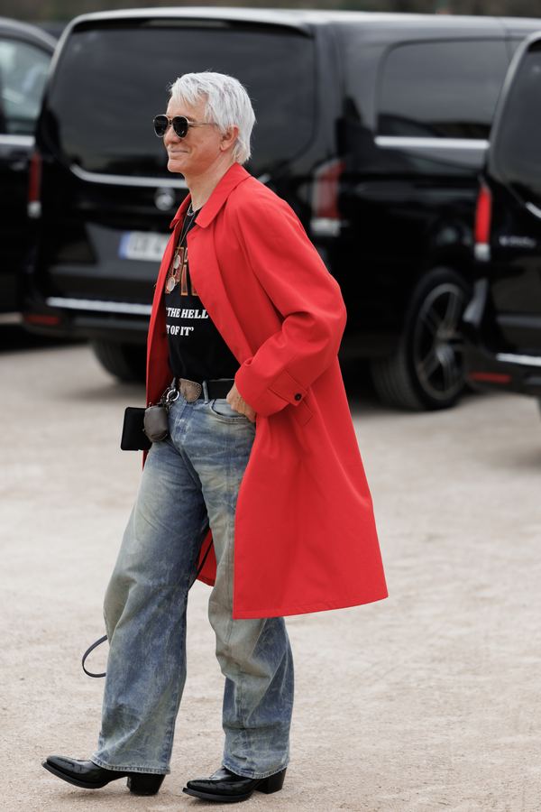 Street style at Paris Fashion Week: red long coat, washed wide-leg jeans, black sunglasses, Paris