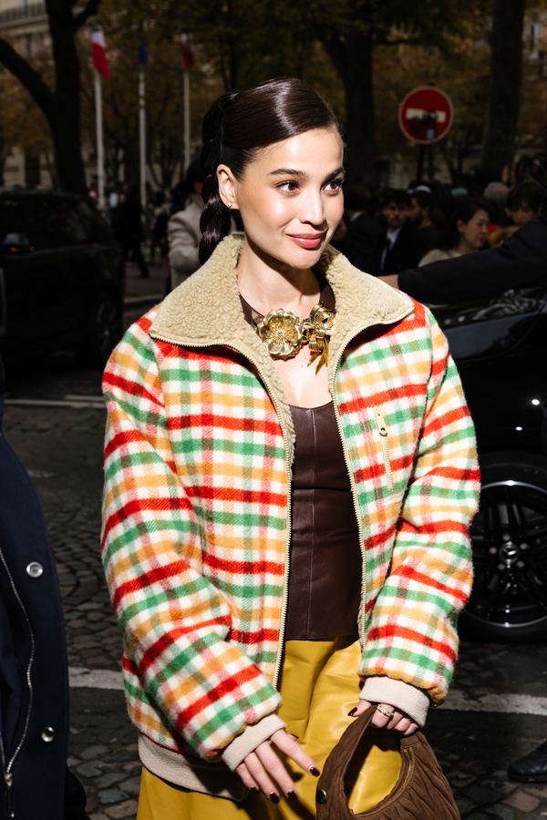 Street style at Paris Fashion Week: plaid shearling jacket, brown top, gold necklace, Paris