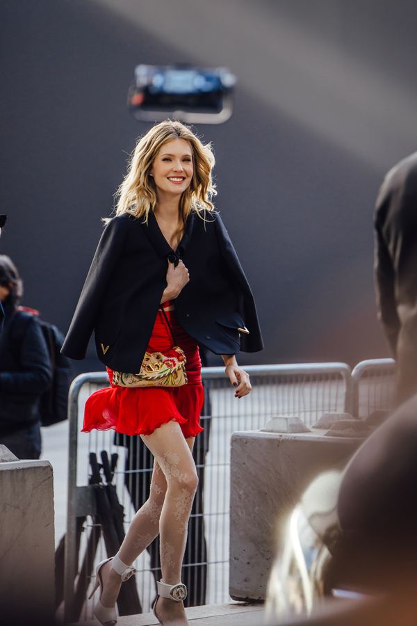 Street style at Paris Fashion Week: red mini skirt, black cape, strappy heels, Paris