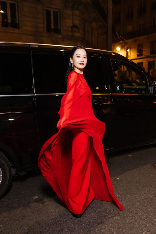 Street style at Paris Fashion Week: flowing red sheer gown, Paris at night