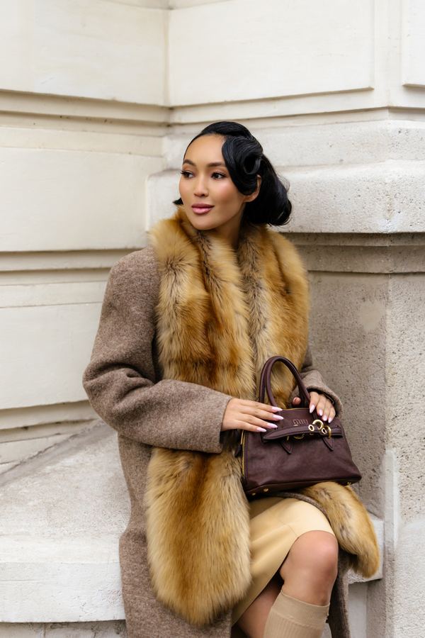 Street style at Paris Fashion Week: camel coat, fox fur stole, brown handbag, Paris