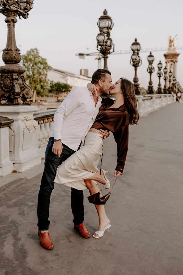 Couple, bridge over the Seine, Paris at golden hour