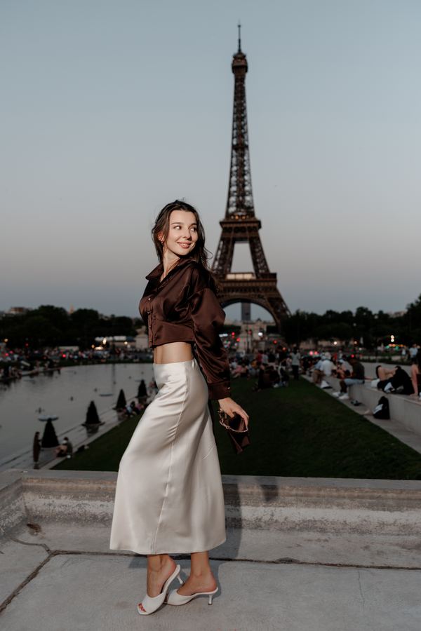 Portrait of a woman in brown satin blouse, cream skirt, Trocadéro, Paris at golden hour