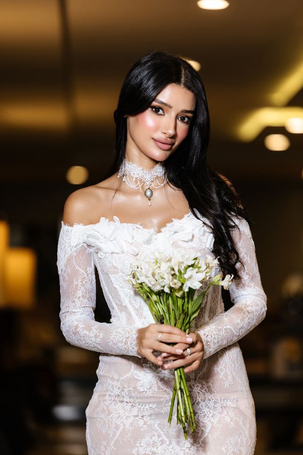 Portrait of a woman in white lace gown, bouquet, hotel interior, Paris
