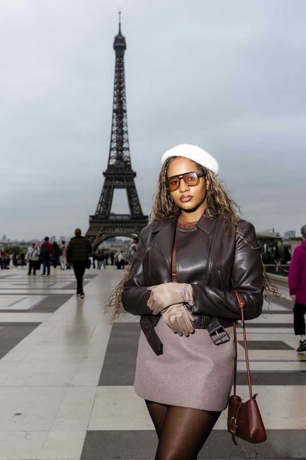 Portrait of a woman in brown leather jacket, beige mini skirt, white beret, sunglasses, Trocadéro, Paris