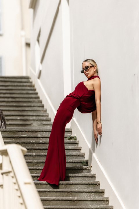 Full-length portrait against the wall beside the steps