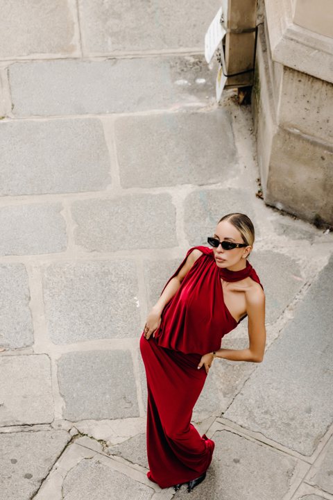 Red dress against a pale stone wall, viewed from above