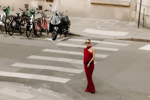 Wide street scene with a red dress at a pedestrian crossing